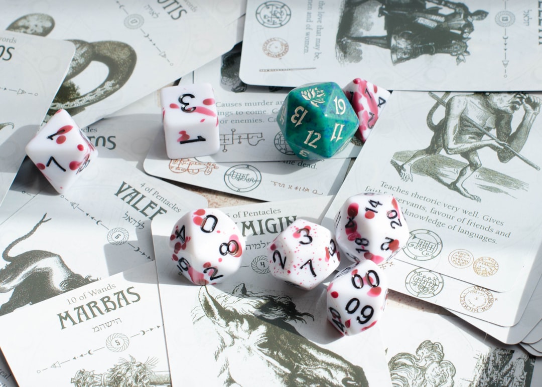 a-pile-of-dice-sitting-on-top-of-a-pile-of-cards-eswucpwz00m